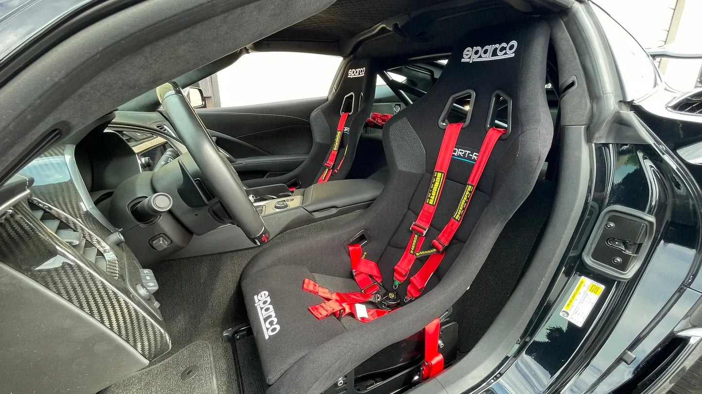 Interior view of WPM C7 Corvette with Sparco racing seats and harnesses, showcasing roll bar compatibility for track days.