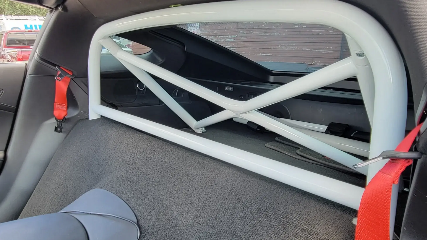WPM C7 Corvette Clubsport Half Cage roll bar installed in car, featuring white finish and robust design for track day safety.