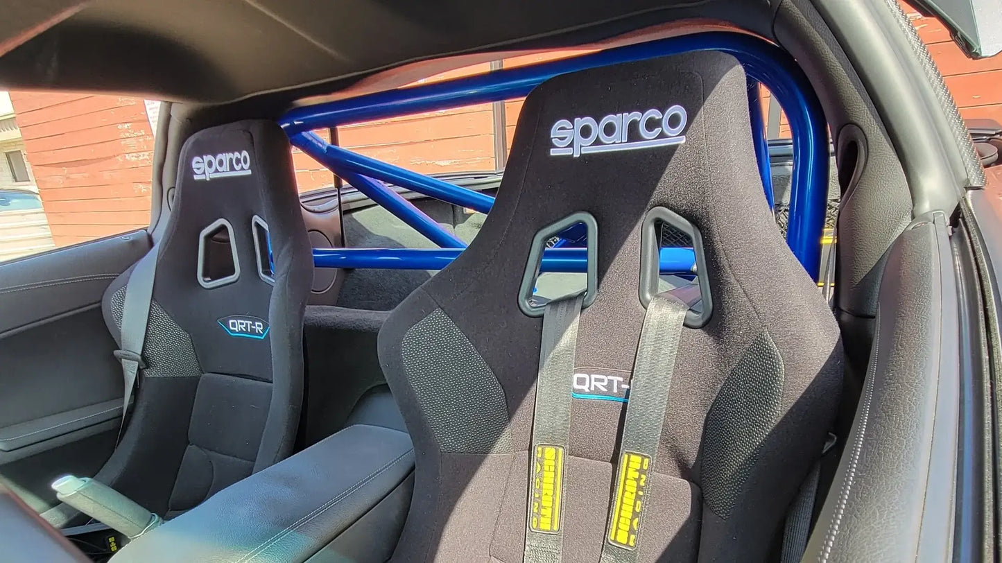 WPM C6 Corvette Clubsport Half Cage with Sparco QRT seats showing quality roll bar construction in a sports car interior.