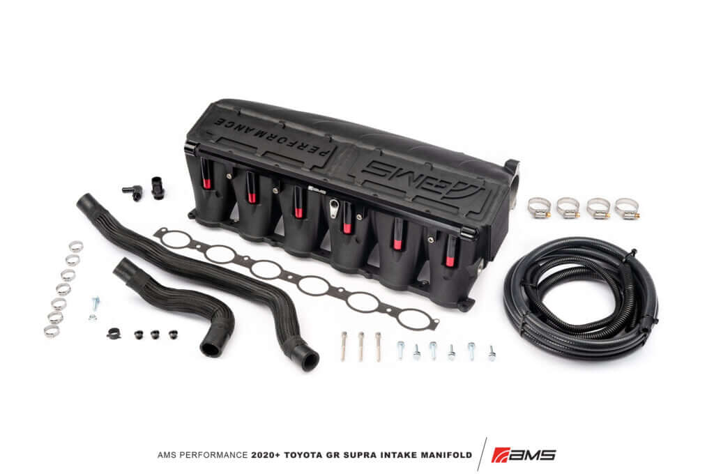 AMS Performance Toyota GR Supra intake manifold with fuel rail, hoses, and hardware for enhanced engine performance.