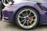 Close-up of a purple Porsche 911 GT3 featuring high-performance wheels and brake calipers.