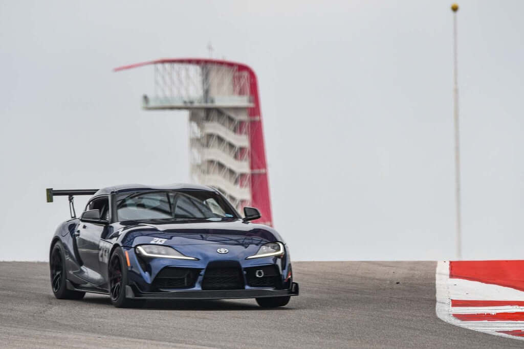 Toyota Supra equipped with Verus A90 front splitter, enhancing downforce and performance on the racetrack.