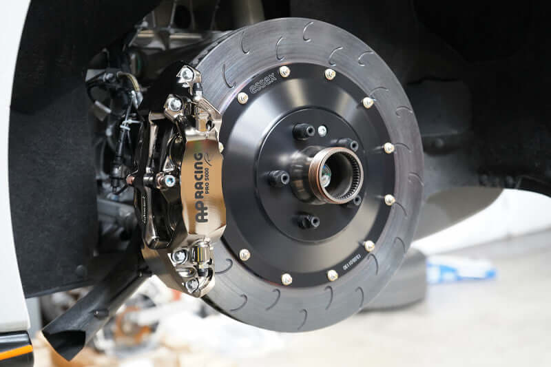 AP Racing 9449 380mm ENP rear brake kit installed on McLaren, featuring durable caliper and rotor.