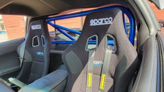WPM C6 Corvette Clubsport Half Cage with Sparco QRT seats showing quality roll bar construction in a sports car interior.