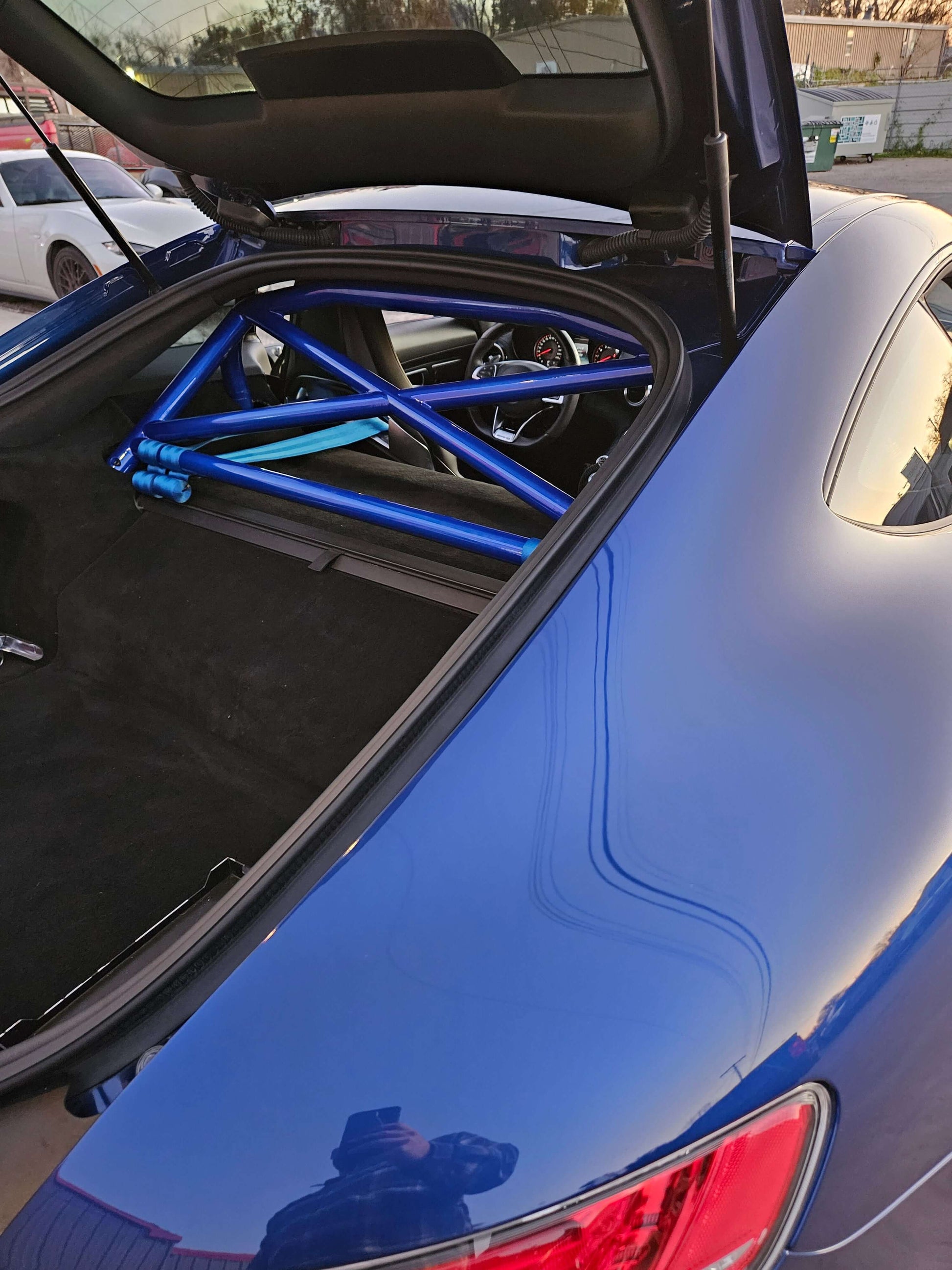 Blue AMG GT featuring a bolt-in roll bar for enhanced safety and performance.