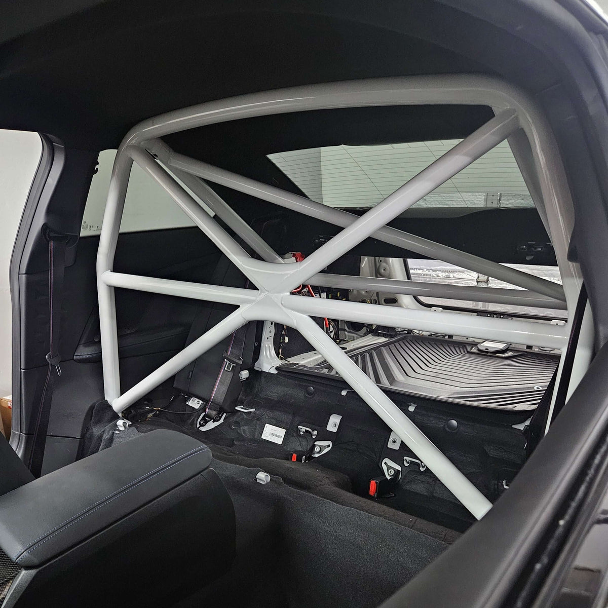WPM G87 M2 Clubsport Half Cage installed in a car interior, enhancing safety and structural support.