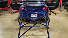 WPM GR86 roll bar installed in a blue Toyota GR86, showcasing welded base plates and strong design for chassis reinforcement.