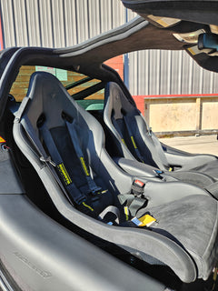 Mclaren 720S Coupe seats featuring 6pt racing harnesses for enhanced safety and style in a sleek interior.