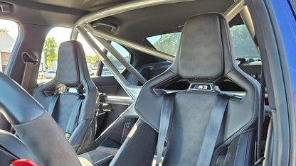 WPM G80 M3 Clubsport Half Cage installed in a BMW M3, showcasing racing seats and safety features.
