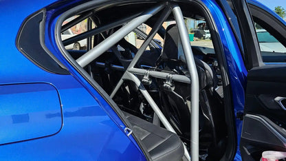 WPM G80 M3 Clubsport half cage view from inside a blue car, showcasing its sturdy design and seatbelt mounts.